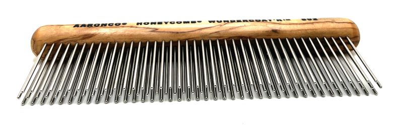 The Aaronco®  Wundercoat'R™ Grooming Comb was developed by industry leader Sam Kohl, This revolutionary 7" design has 3 rows of 1.75” tines created to remove dense undercoat, and reduce excess topcoat. Its ergonomic wooden handle reduces wrist and hand strain, while its tines offer increased coat removal compared to brushing alone, without resulting in damage to the fur or skin.